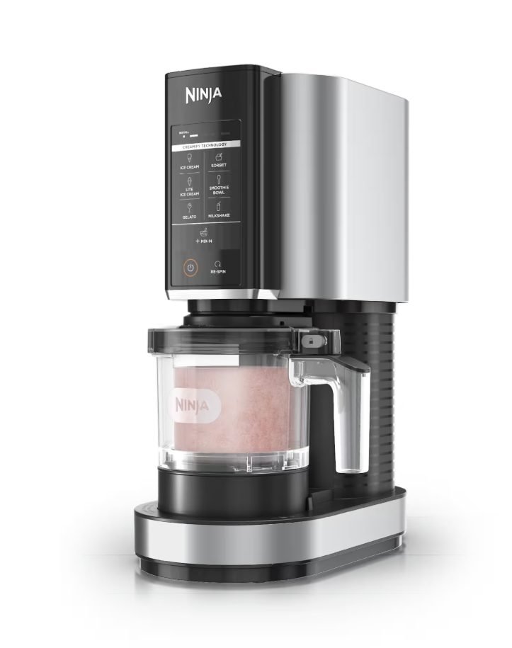 Ninja CREAMi with a frozen pink pint locked into the machine